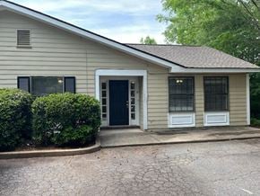 Newnan house for rent - A house with a black door and a small front porch.