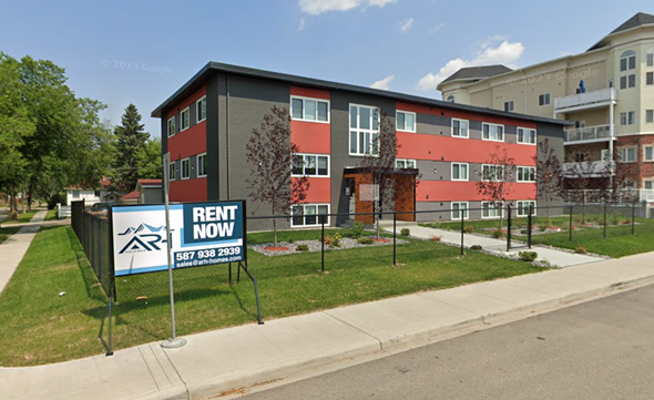 Edmonton apartment for rent - a rent now sign in front of an apartment building