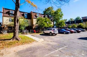 Washington apartment for rent - a parking lot with cars parked in front of an apartment building