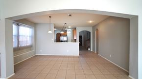 Rockwall house for rent - A spacious living room with a kitchen in the background.