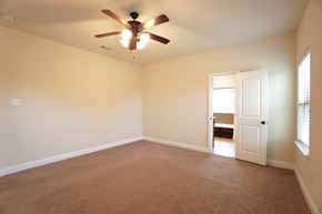 Greenville house for rent - a empty living room with a ceiling fan