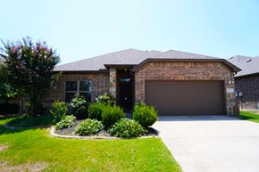 Greenville house for rent - a house with a driveway and a garage door