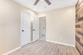 Cleveland house for rent - an empty room with two doors and a ceiling fan