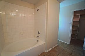 Royse City house for rent - A white bathtub with a shower head and faucet.