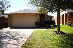 Royse City house for rent - A house with a garage and a tree in front.