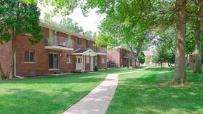 Gibraltar apartment for rent - a row of brick apartment buildings with a sidewalk