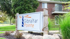Gibraltar apartment for rent - a sign for the gibraltar point apartments in front of a building