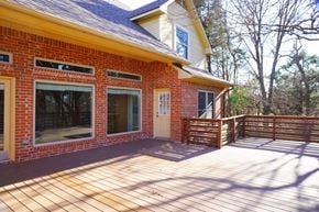 Rockwall house for rent - A red brick house with a wooden deck.