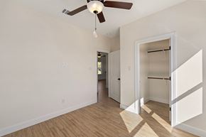 Hondo house for rent - a living room with a ceiling fan and a hallway to a closet