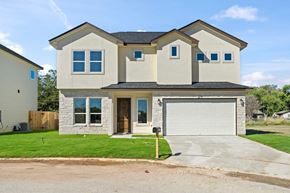Hondo house for rent - a beige house with a garage and a driveway