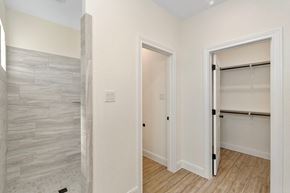 Hondo house for rent - a bedroom with a closet and a door to a bathroom