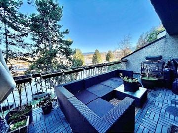 Vancouver apartment for rent - a balcony with a view of a lake and trees
