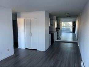 Vancouver apartment for rent - an empty living room with white walls and wood floors