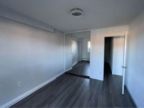 Vancouver apartment for rent - an empty living room with white walls and wood floors