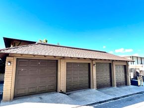 Oceanside apartment for rent - a garage with three garage doors and a roof