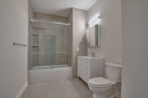 Nyack apartment for rent - A white bathroom with a toilet, sink, and shower.