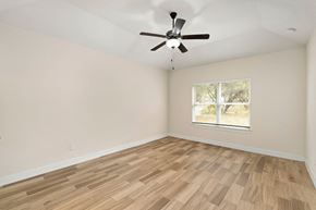 Spring Branch apartment for rent - the spacious living room with hardwood flooring and a ceiling fan