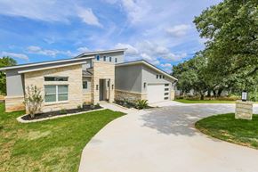 Horseshoe Bay house for rent - a house with a driveway and trees in front of it
