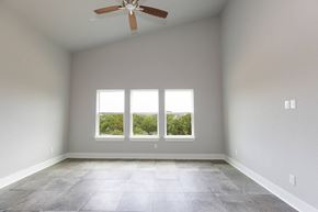 Horseshoe Bay house for rent - an empty room with three windows and a ceiling fan