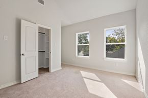 San Antonio apartment for rent - an empty bedroom with a white door and two windows