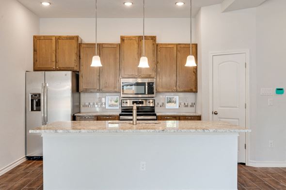San Antonio apartment for rent - a kitchen with wooden cabinets and a marble counter top