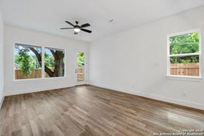 San Antonio apartment for rent - an empty living room with wood floors and a ceiling fan