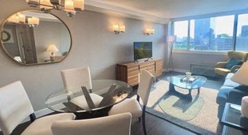 Philadelphia apartment for rent - a living room with white chairs and a glass table