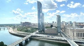 Philadelphia apartment for rent - a bridge over a river in a city with tall buildings