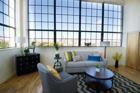 Hartford apartment for rent - A living room with a grey couch, a black dresser, and a coffee table.