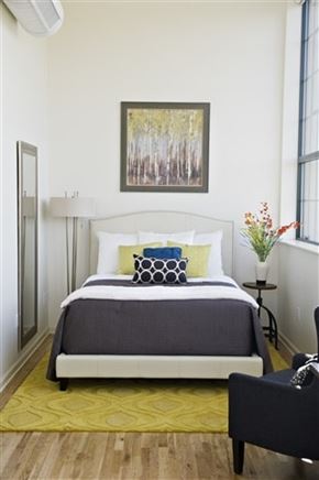 Hartford apartment for rent - A bedroom with a bed, a chair, and a painting on the wall.