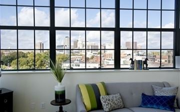 Hartford apartment for rent - A living room with a grey couch and a green pillow.