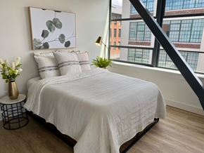 Hartford apartment for rent - A bedroom with a large bed and a painting on the wall.