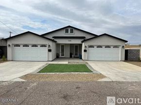 Phoenix apartment for rent - a white house with two garage doors and a driveway