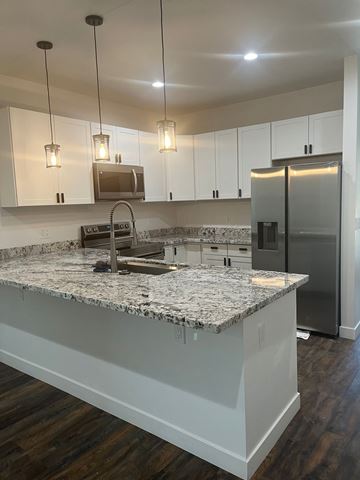 Phoenix apartment for rent - a kitchen with white cabinets and a granite counter top