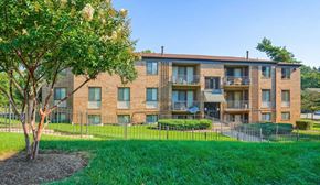Capitol Heights apartment for rent - a brick apartment building with a yard and a tree