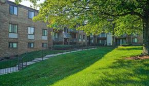 Capitol Heights apartment for rent - a green lawn in front of a brick building