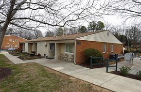 Gastonia apartment for rent - a small white house with a porch and a sidewalk
