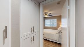 El Cajon apartment for rent - a bedroom with white cabinets and a ceiling fan