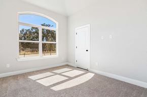 Hondo house for rent - an empty bedroom with a window and a door