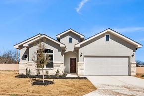 Hondo house for rent - a white house with a garage and a driveway