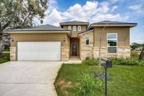 Hondo house for rent - a house with a driveway and a garage door