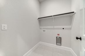 Hondo house for rent - the living room has a white wall and a white door to the garage