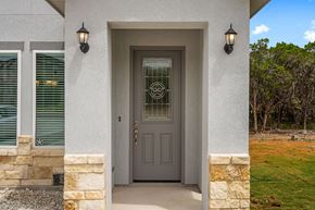 Spring Branch apartment for rent - the front door of a house with a gray door and two lamps on either side