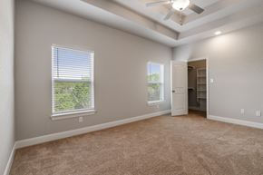 Spring Branch apartment for rent - an empty living room with two windows and a ceiling fan