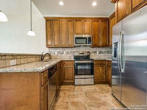 Spring Branch apartment for rent - a kitchen with wooden cabinets and stainless steel appliances