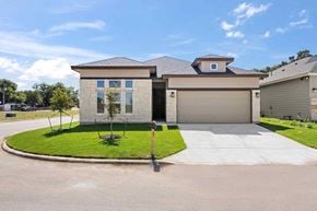 Hondo house for rent - a house with a driveway and a lawn in front of it
