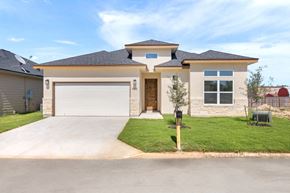 Hondo house for rent - a house with a driveway and a garage door