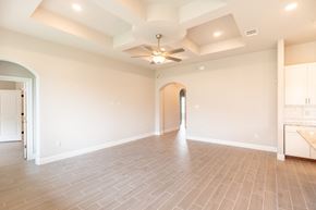 Hondo house for rent - the spacious living room with a ceiling fan and tile flooring