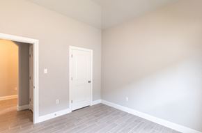 Hondo house for rent - a empty room with a white door and a tile floor