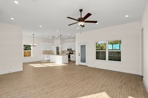Hondo house for rent - a living room with a ceiling fan and a kitchen